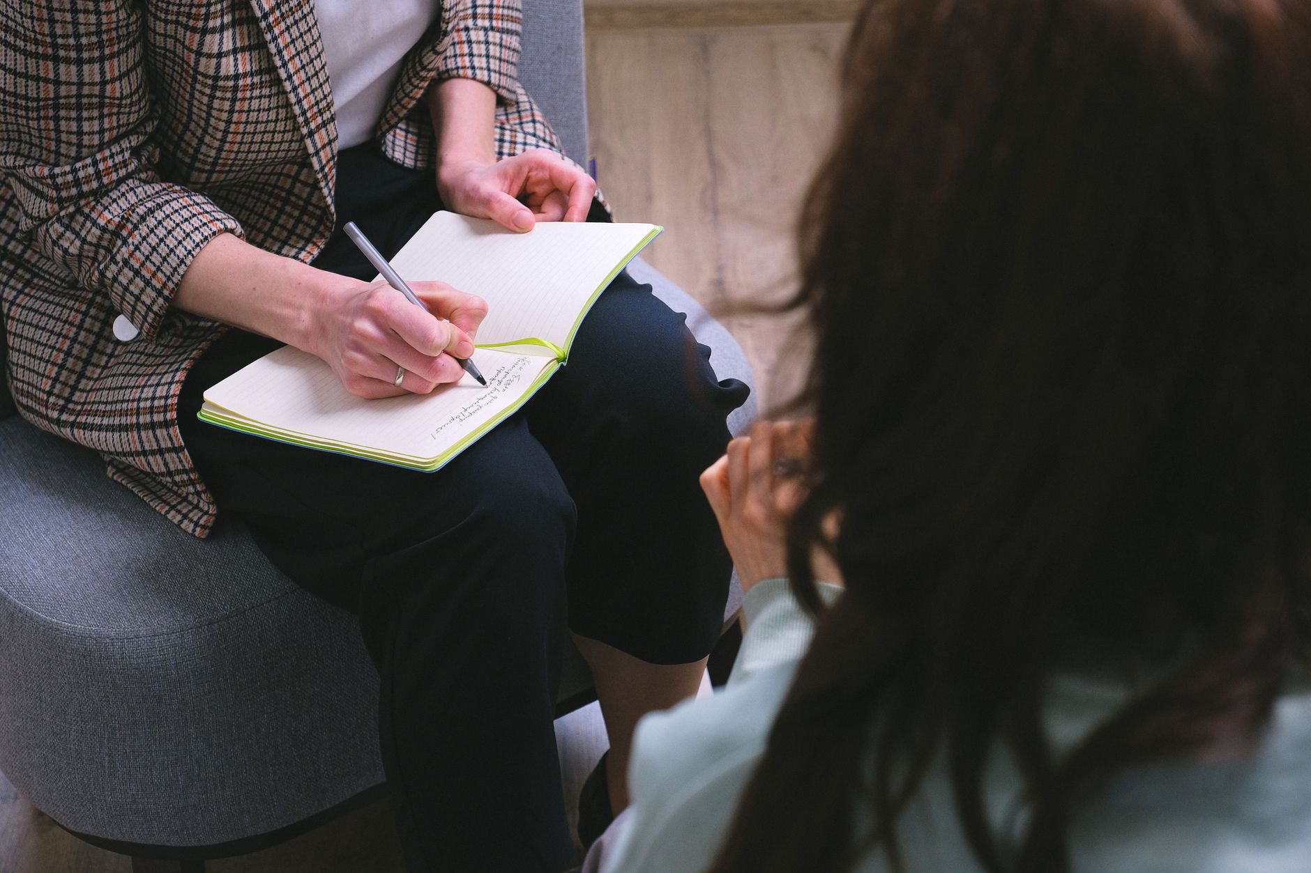 crop counselor writing in diary while talking to patient